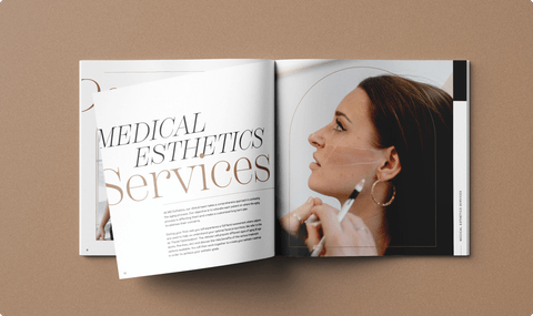 MD Esthetics printed book's "Services" page mid-folding