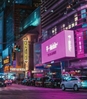 Times Square lit up at night, showing many brands off