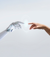 Robotic hand reaching out to touch a human hand with a futuristic disc of light in between