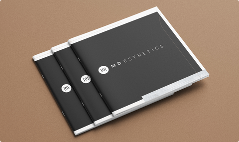 3 printed books featuring the cover "MD Esthetics"